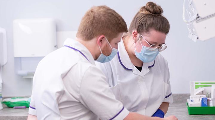 two pharmacists preparing medicines tray