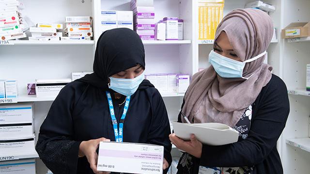 two people working in a pharmacy premises